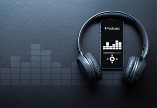 image of some headphones and a media player on a dark background