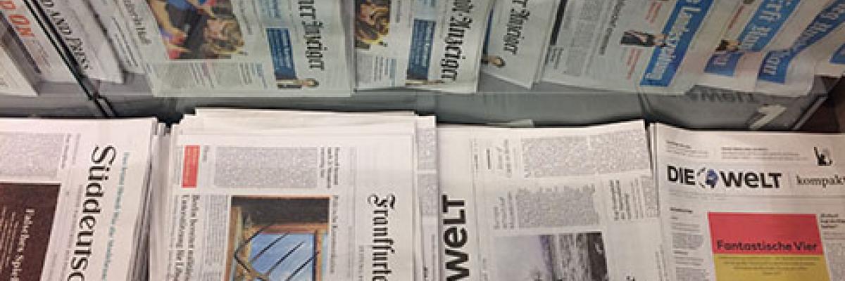 image of a selection of German newspapers in a newspaper stand
