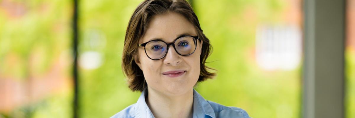 Image of a person wearing glasses and a blue shirt