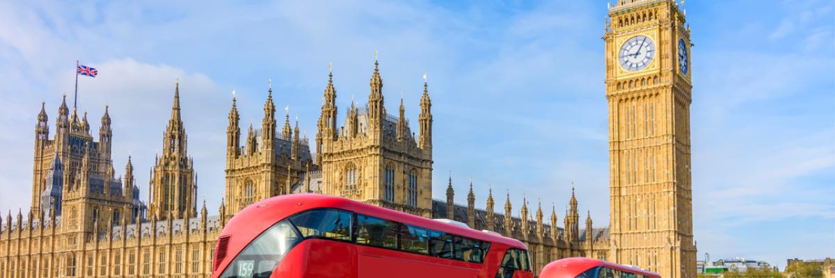 Image of double decker buses in front of a building