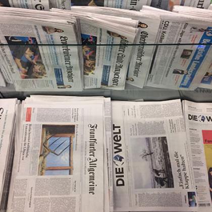 image of a selection of German newspapers in a newspaper stand