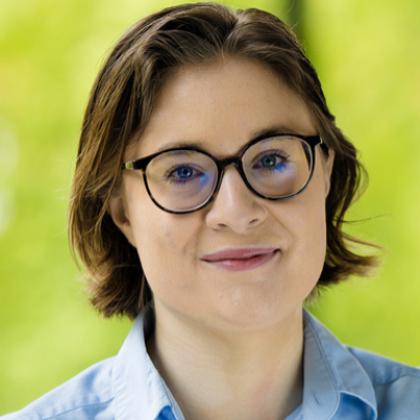 Image of a person wearing glasses and a blue shirt