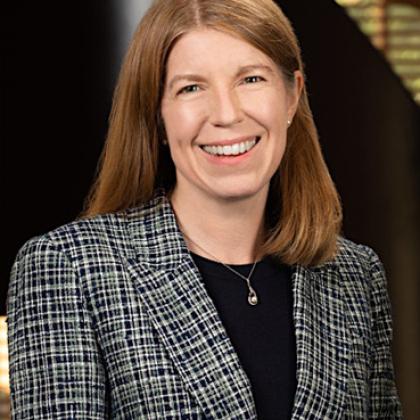 Image of a woman with long hair smiling at the camera