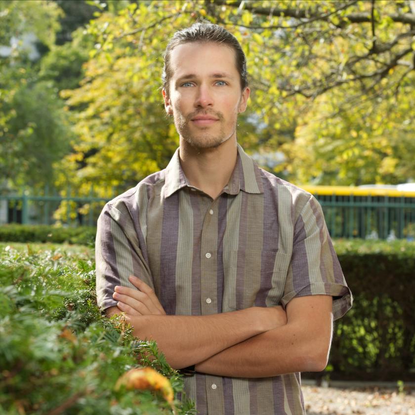 image of a man with crossed arms smiling at the camera